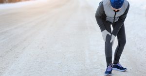 Injuries - sports running knee injury on woman. Winter marathon; blog: 10 Tips for Relieving Joint Pain in Winter