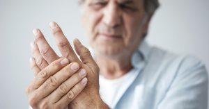Old man with finger pain; blog: 9 Arthritis Treatment Options